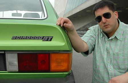 Unser Autor Sebastian Viehmann mit dem VW Scirocco I - stilecht mit Sonnenbrille und grün kariertem Hemd