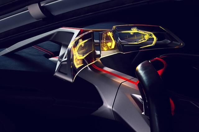 Hinter dem Volant, das mit zwei kleinen Monitoren versehen ist, findet sich ein transparenter, gebogener Bildschirm, durch den man auf die Windschutzscheibe blickt
