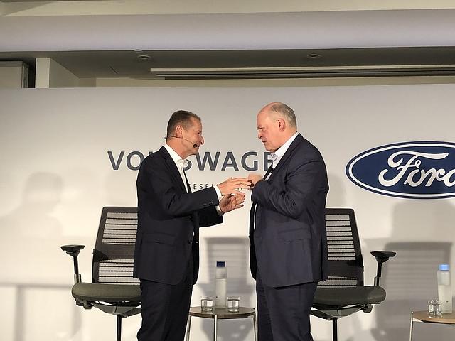 Herbert Diess links und Ford Chef Jim Hackett besiegeln die Zusammenarbeit