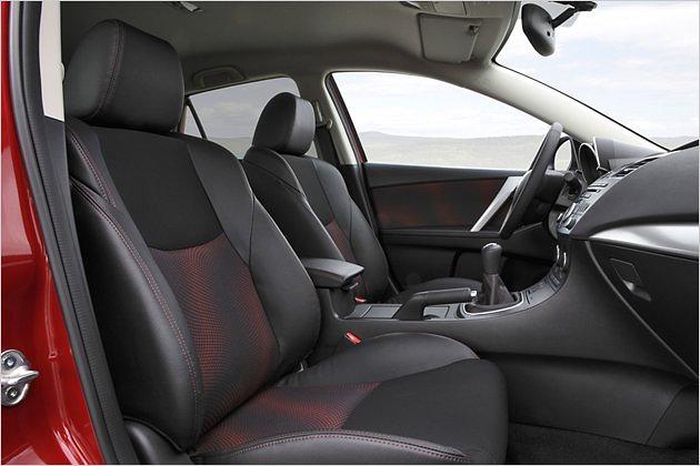 Fahrer und Beifahrer nehmen auf serienmäßigen Sportsitzen Platz